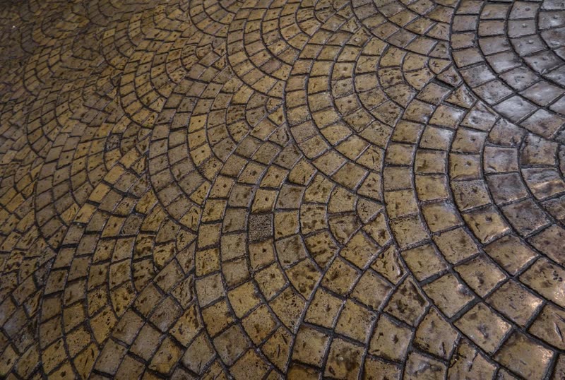 Close-up of stamped concrete in a fan-shaped cobblestone pattern